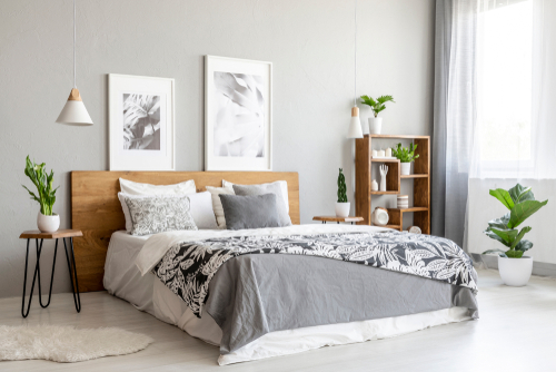 Patterned,Blanket,On,Wooden,Bed,In,Grey,Bedroom,Interior,With